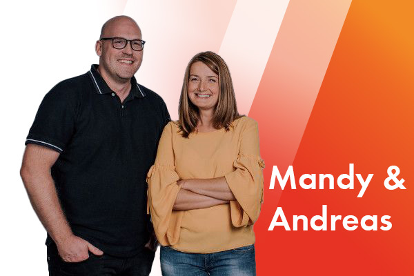 Zwei Personen stehen nebeneinander. Der Mann trägt ein schwarzes Polohemd und eine Brille, die Frau ein gelbes Oberteil und Jeans. 